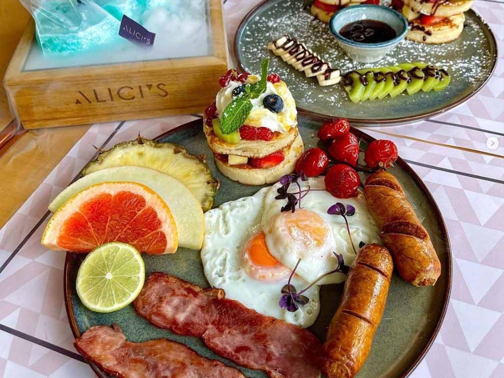 A full english including fried eggs, bacon and sausage also served with fresh fruit and pancakes
