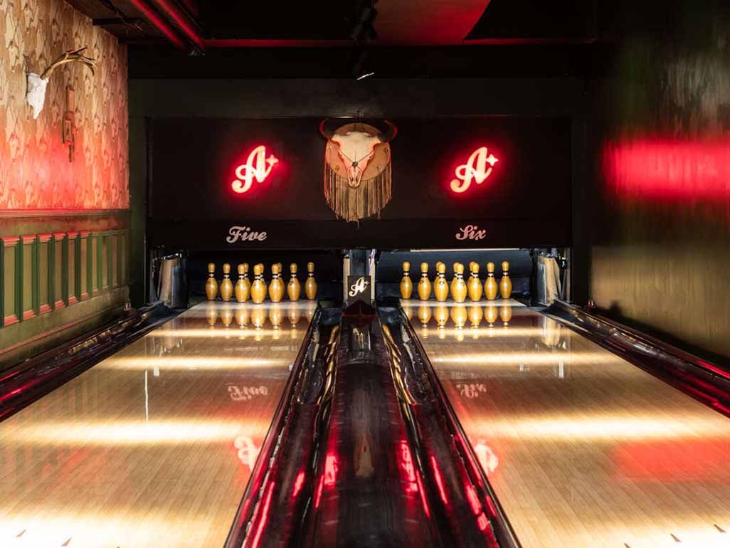 All star lanes bowling alley with neon lights and bowling pins