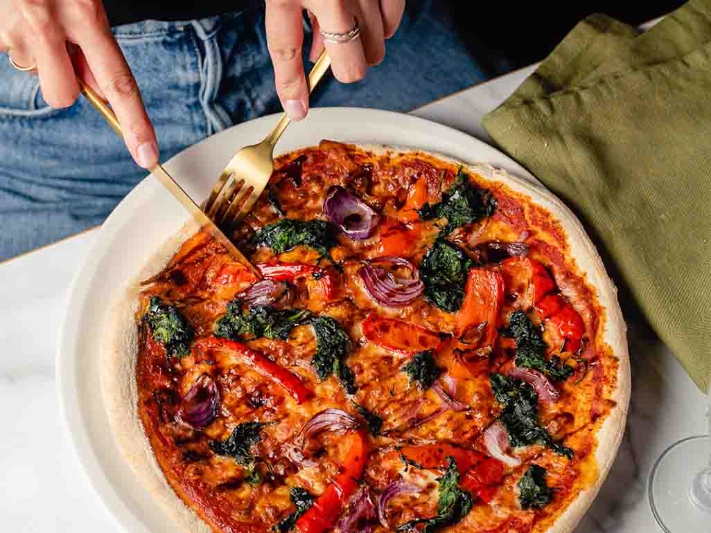 Vegan pizza from Bella Italia with peppers, red onion and spinach