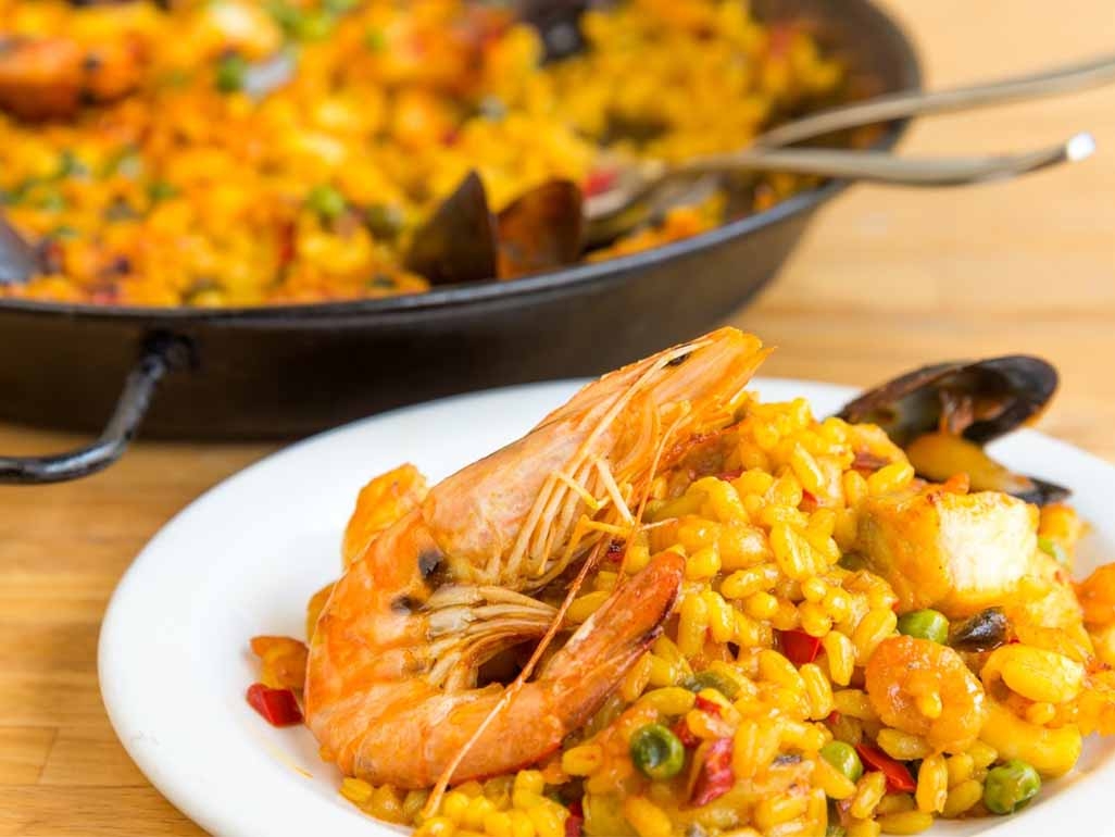 Paella served with king prawns
