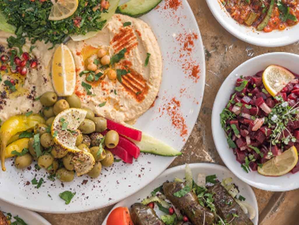 Hummus served with olives and salad