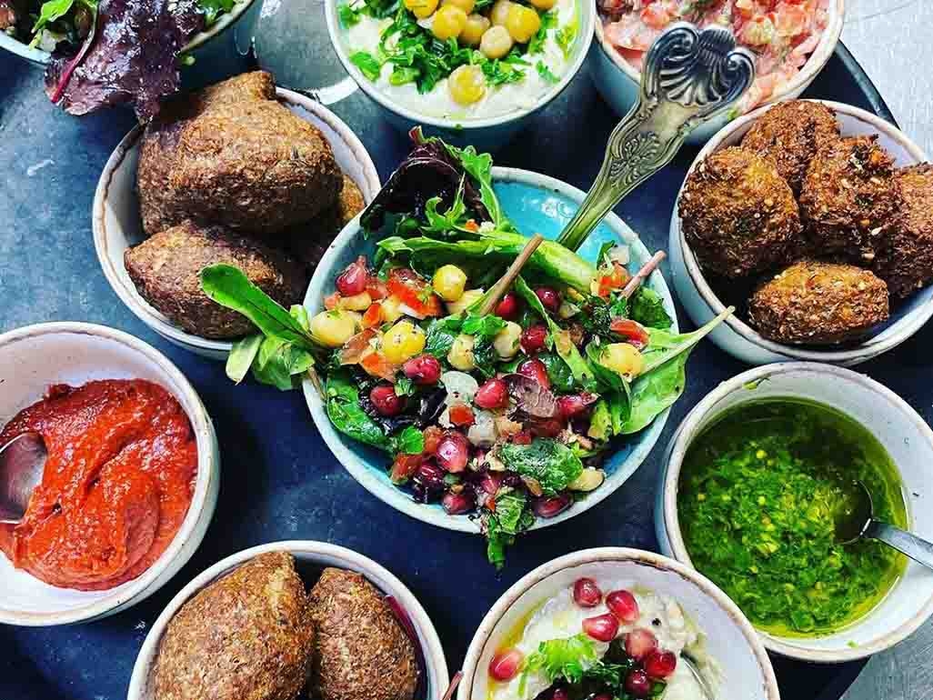 Falafel balls, rainbow salad with lettuce, sweetcorn and pomegranate seeds