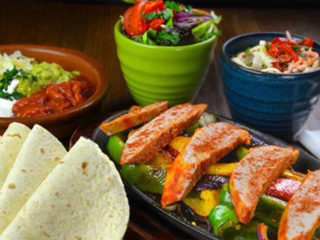 Chicken and roasted peppers served with tortillas, salsa and guacamole