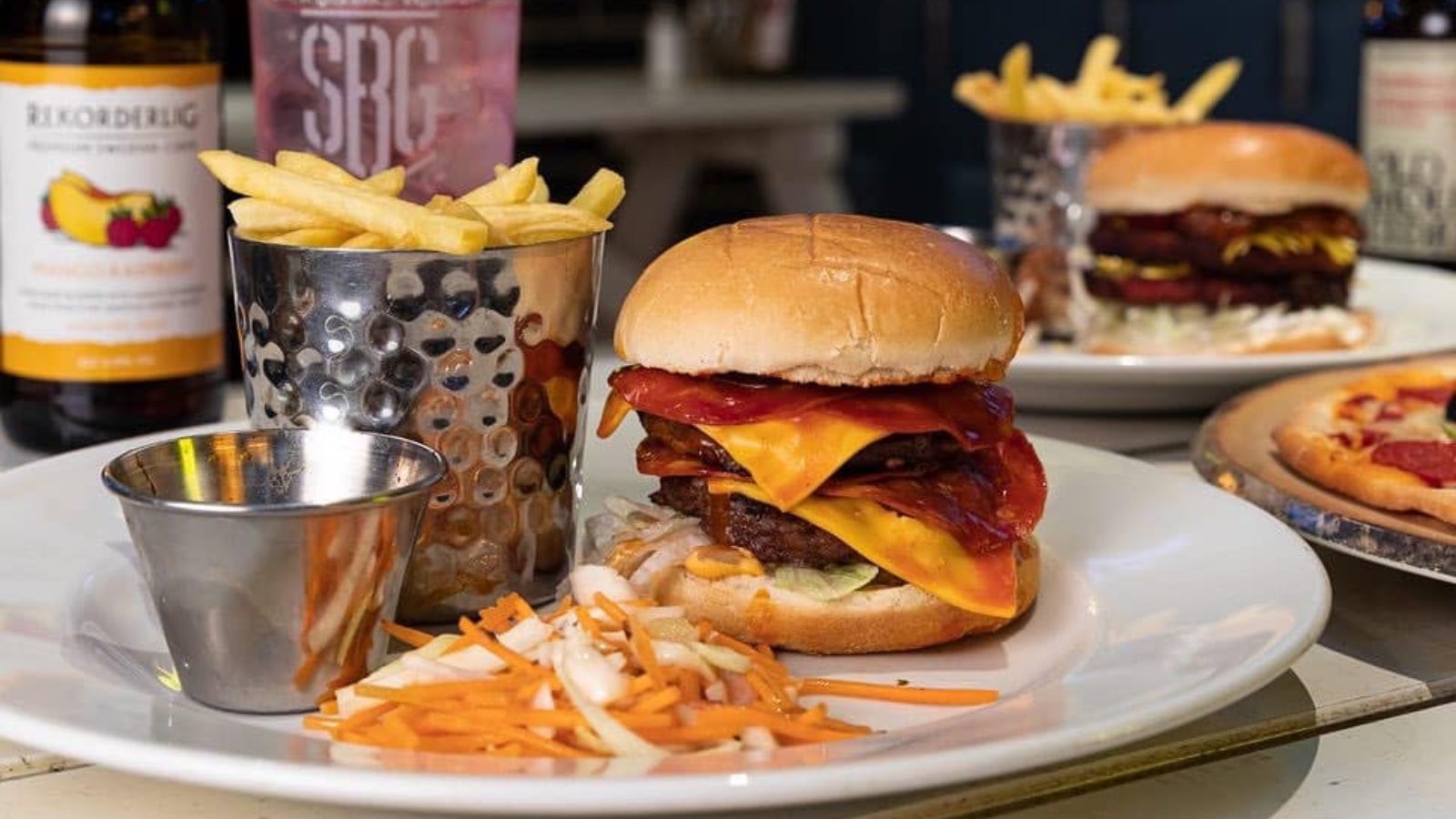 A double bacon cheese beef burger served with fries
