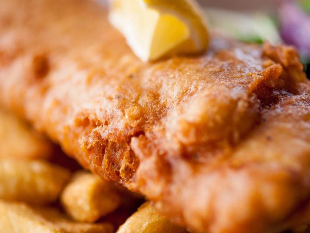 A close up of a crispy battered fish