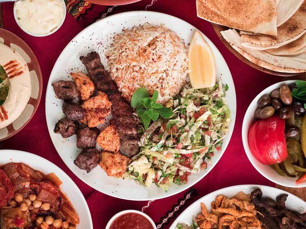 Beef and chicken served with rice and salad